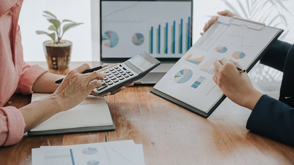 Emma Norris Accounting background image of accounting reports and a calculator
