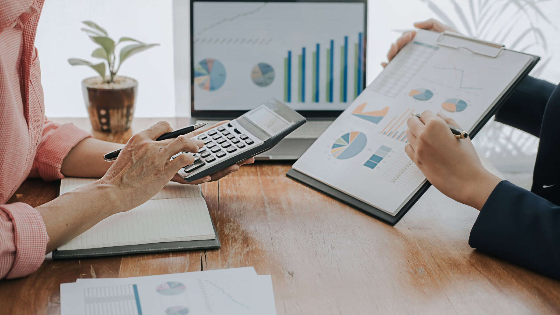 Emma Norris Accounting background image of accounting reports and a calculator